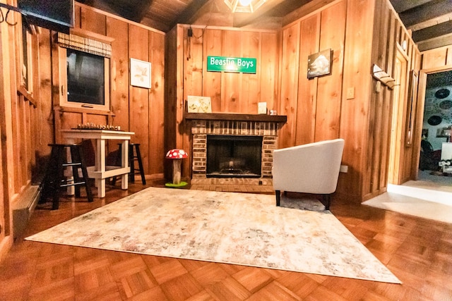 sitting room featuring dark parquet flooring, a brick fireplace, and wood walls