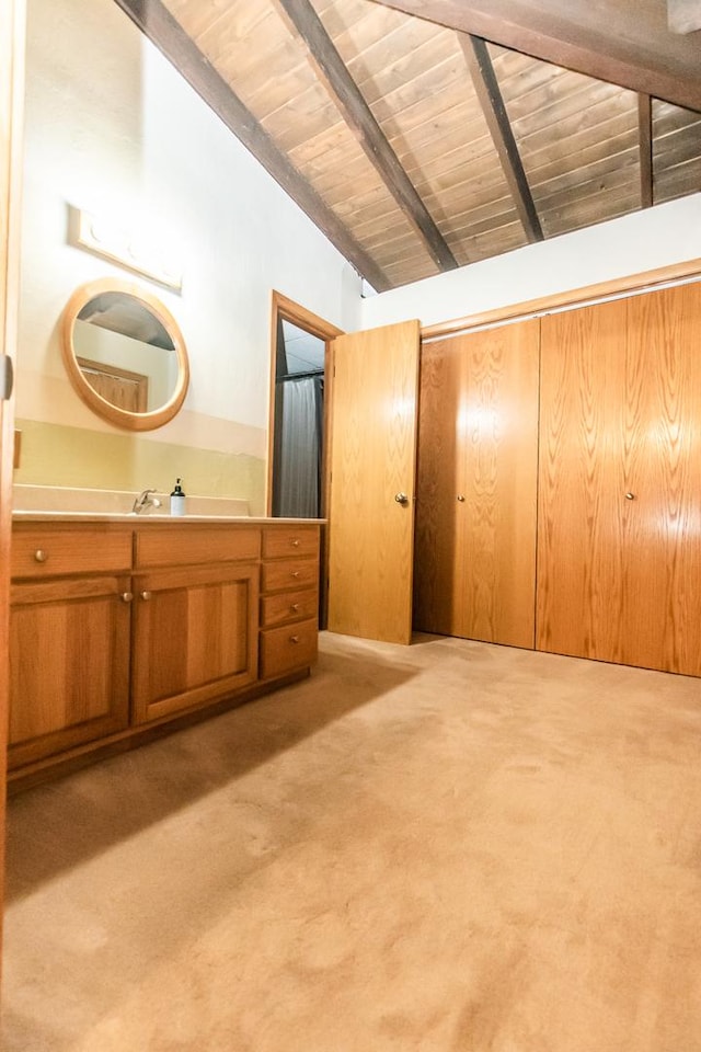 bathroom featuring lofted ceiling with beams, wooden walls, vanity, and wood ceiling