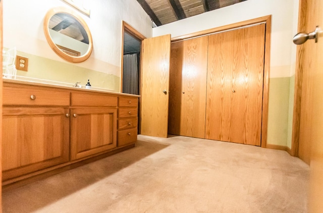 bathroom with vaulted ceiling with beams, vanity, and wooden ceiling