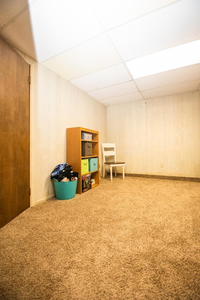 recreation room featuring carpet floors and a drop ceiling