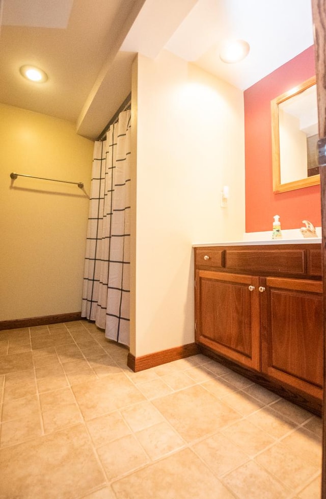 bathroom with tile patterned flooring, vanity, and curtained shower