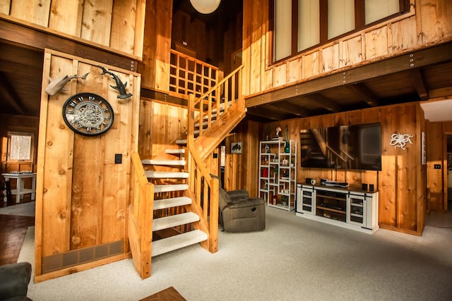 interior space featuring wood walls and carpet