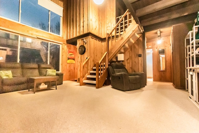 living room featuring carpet floors and wooden walls