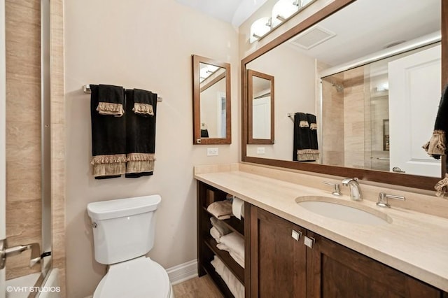 full bathroom featuring vanity, toilet, and bath / shower combo with glass door