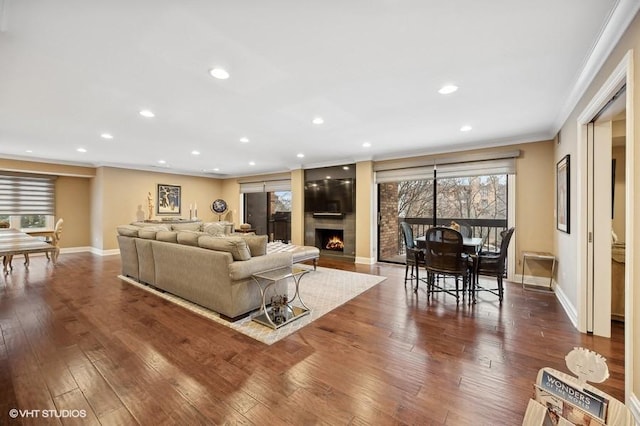 living room with ornamental molding and hardwood / wood-style flooring