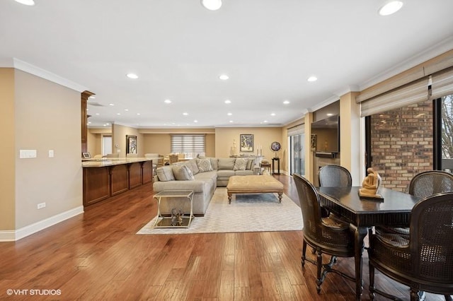 living room featuring hardwood / wood-style flooring and crown molding