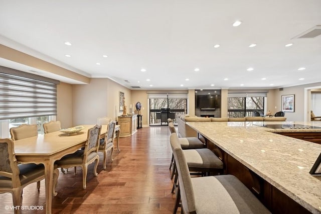 dining space featuring crown molding and wood-type flooring