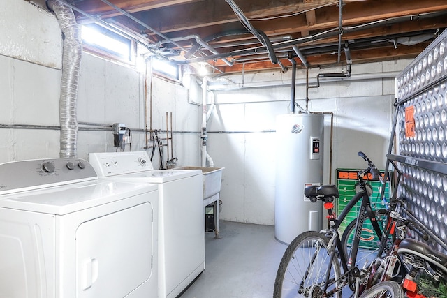 laundry room with electric water heater, washer and clothes dryer, and sink