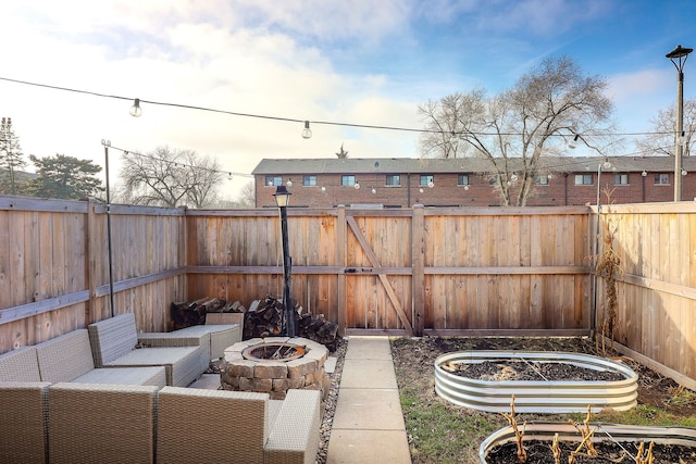 view of patio / terrace with an outdoor living space with a fire pit