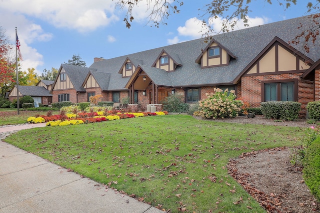 tudor-style house with a front yard