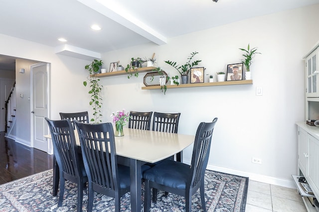 tiled dining area with beamed ceiling