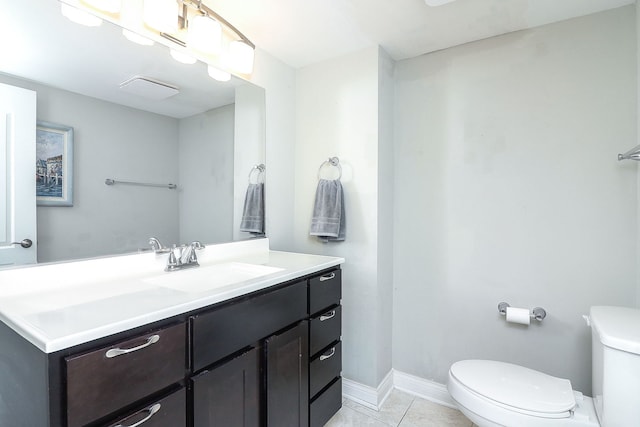 bathroom featuring toilet, vanity, and tile patterned floors