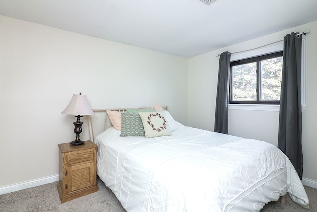 bedroom featuring light carpet