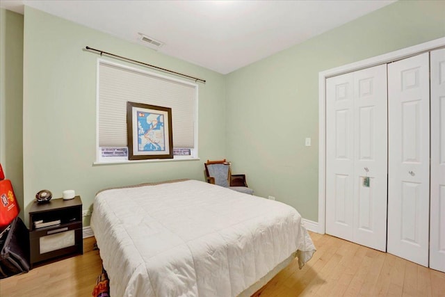 bedroom featuring light hardwood / wood-style floors and a closet