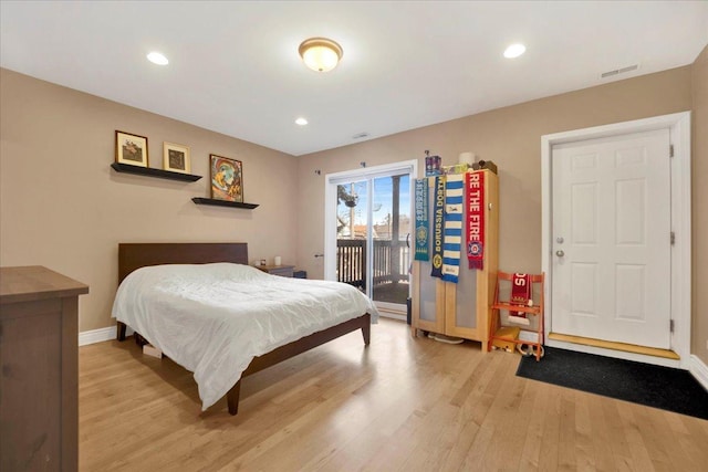 bedroom featuring access to exterior and light hardwood / wood-style floors