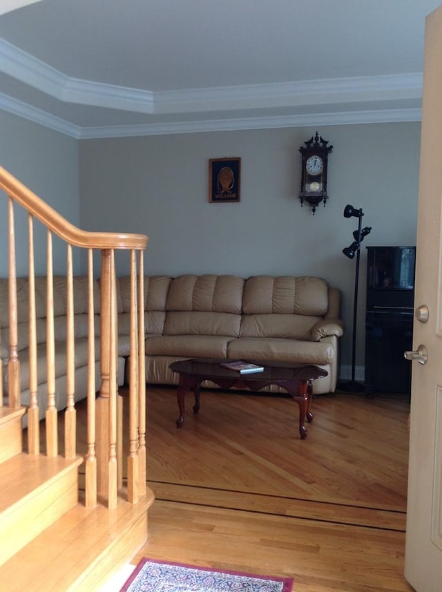 living room with crown molding and light wood finished floors