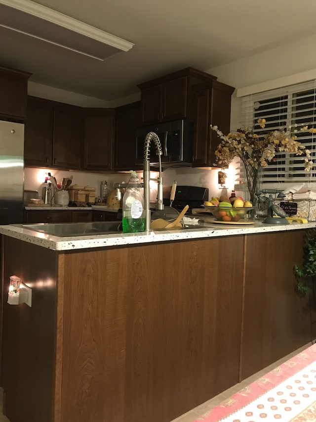 kitchen featuring dark brown cabinets