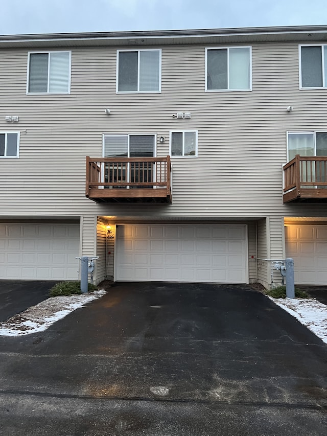 rear view of property featuring a garage