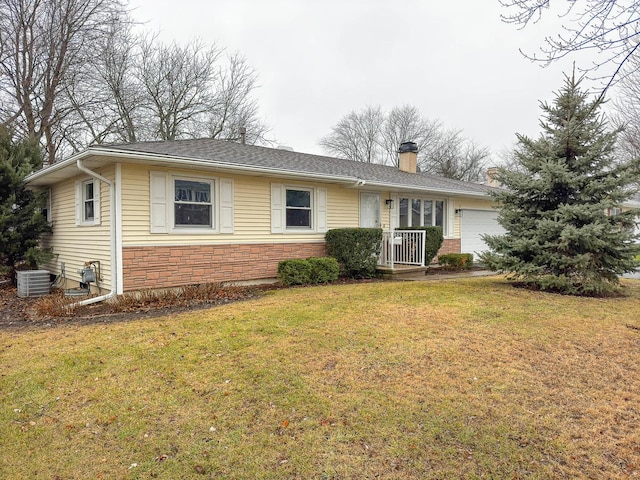 ranch-style home featuring central AC, a garage, and a front lawn