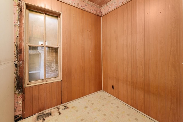 spare room with wood walls