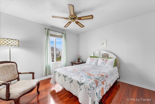 bedroom featuring ceiling fan and dark wood-type flooring