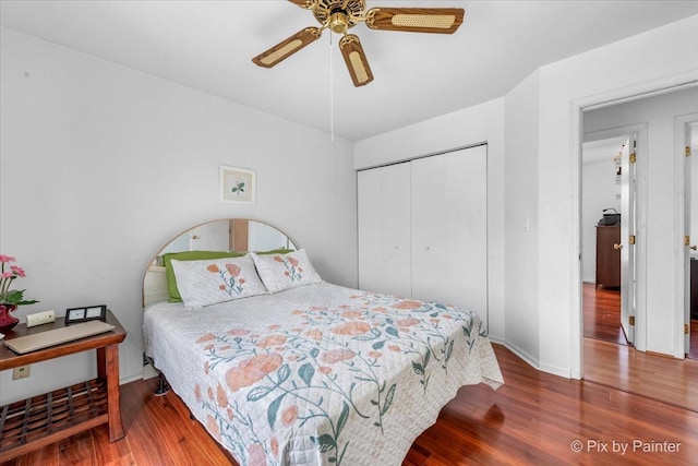 bedroom with hardwood / wood-style floors, a closet, and ceiling fan