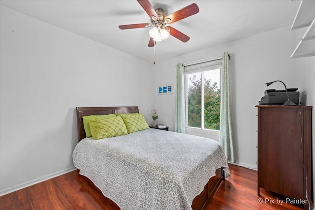 bedroom with ceiling fan and dark wood-type flooring