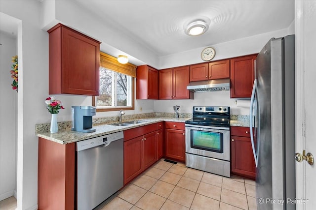 kitchen featuring light stone countertops, sink, light tile patterned floors, and stainless steel appliances