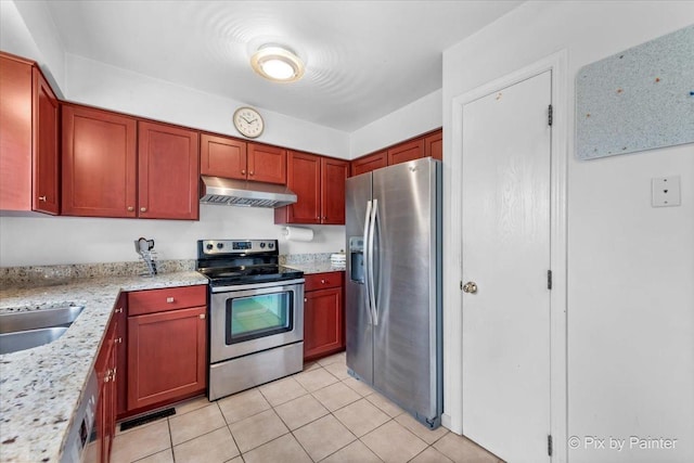 kitchen featuring light tile patterned flooring, light stone counters, sink, and appliances with stainless steel finishes