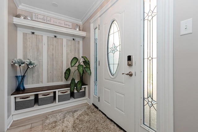 entryway featuring crown molding, baseboards, and wood finished floors