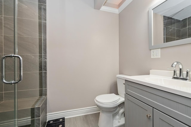 full bathroom with wood finished floors, toilet, a stall shower, and vanity