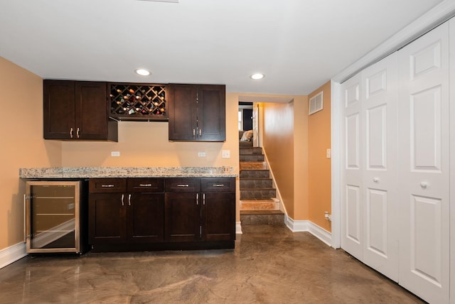 bar with visible vents, baseboards, beverage cooler, recessed lighting, and a bar