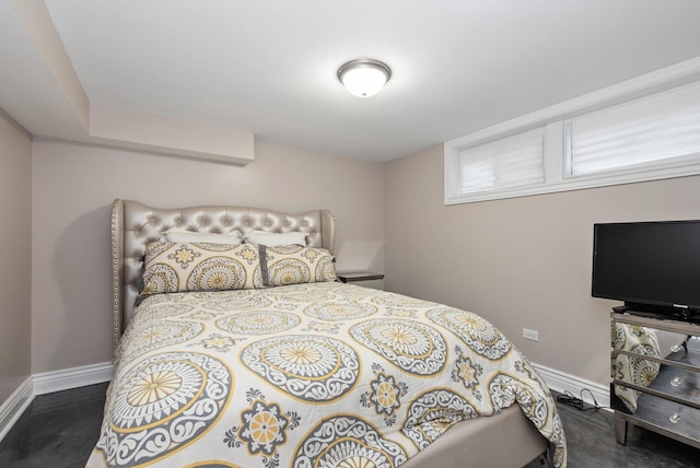 bedroom with wood finished floors and baseboards