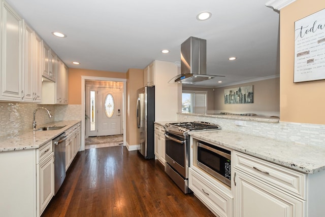 kitchen with dark wood-style flooring, recessed lighting, island range hood, stainless steel appliances, and a sink