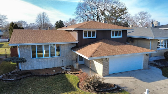 tri-level home with a garage and a front lawn