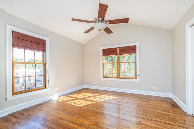 spare room featuring hardwood / wood-style floors, ceiling fan, and lofted ceiling