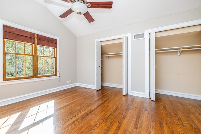 unfurnished bedroom with ceiling fan, hardwood / wood-style floors, and lofted ceiling