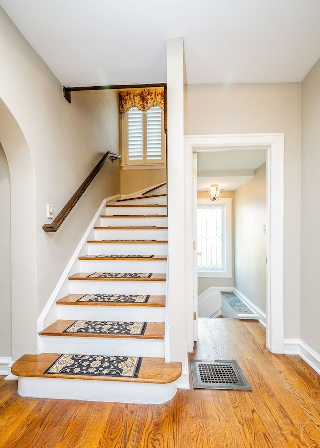 stairway with hardwood / wood-style floors