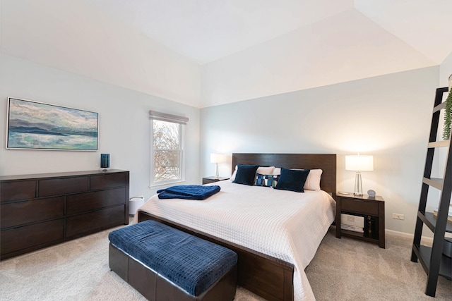 carpeted bedroom with vaulted ceiling