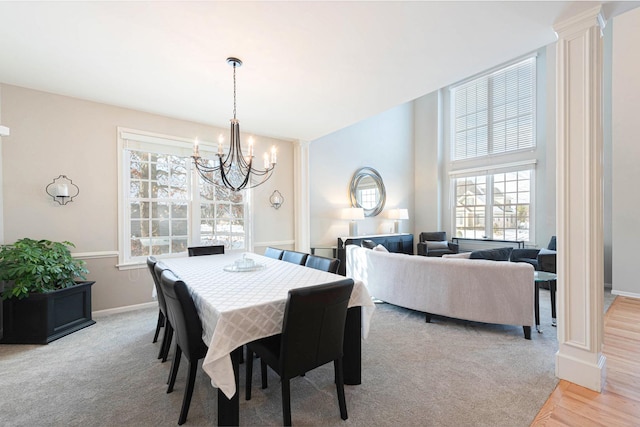 carpeted dining space featuring an inviting chandelier