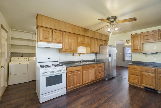 kitchen featuring washer and clothes dryer, sink, white gas range oven, high quality fridge, and dark hardwood / wood-style flooring