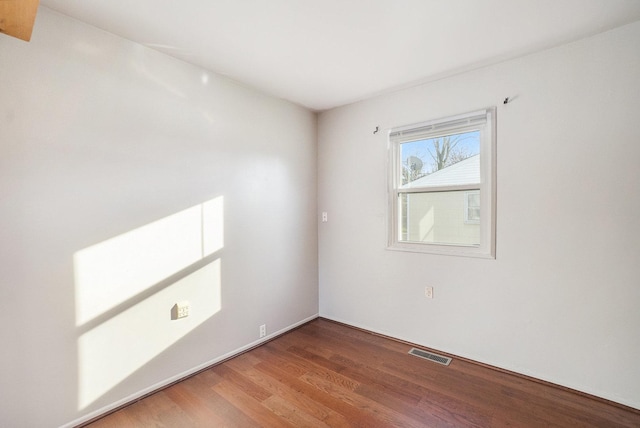 unfurnished room with hardwood / wood-style flooring