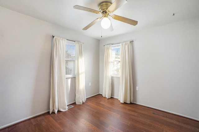 spare room featuring ceiling fan and dark hardwood / wood-style flooring