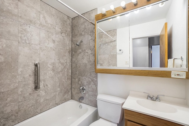 full bathroom with vanity, tiled shower / bath combo, and toilet