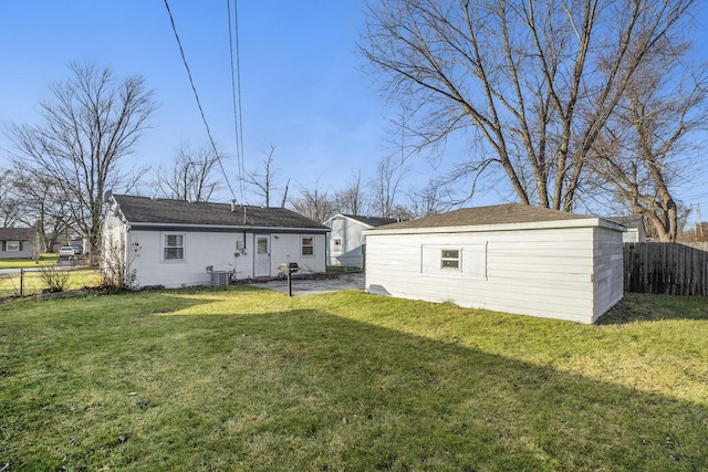 rear view of house featuring a yard