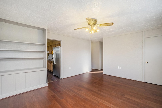 unfurnished living room with ceiling fan, dark hardwood / wood-style flooring, and a textured ceiling