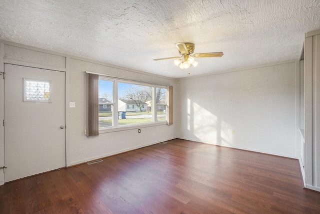 entryway with a textured ceiling, dark hardwood / wood-style floors, and ceiling fan