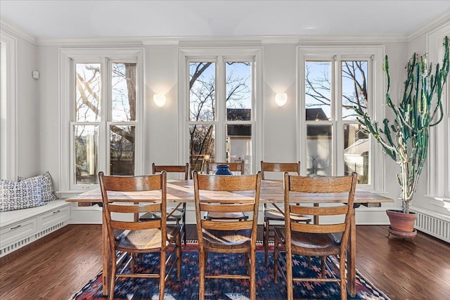 dining area with dark wood-type flooring and ornamental molding