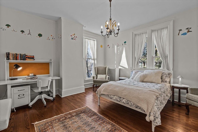 bedroom with dark hardwood / wood-style floors, built in desk, and a notable chandelier