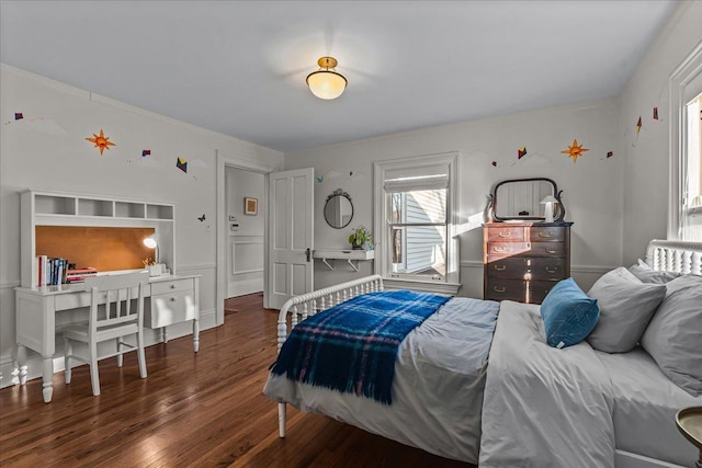 bedroom with dark hardwood / wood-style flooring